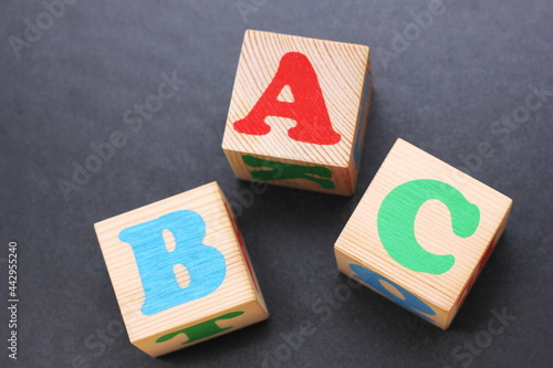 ABC -the first letters of the English alphabet on wooden toy blocks.