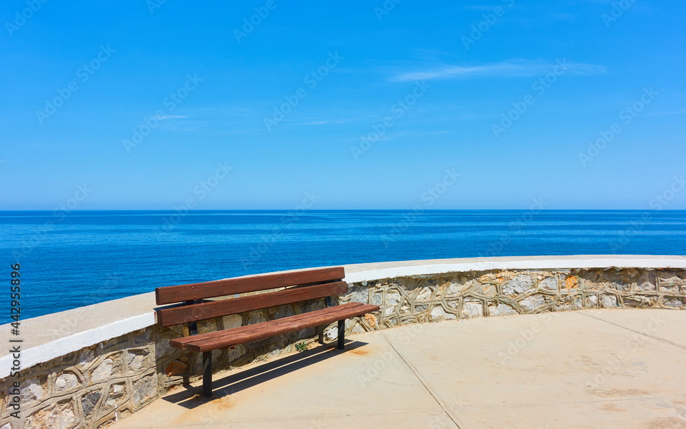 Bench on promenade along the sea in Rethimno