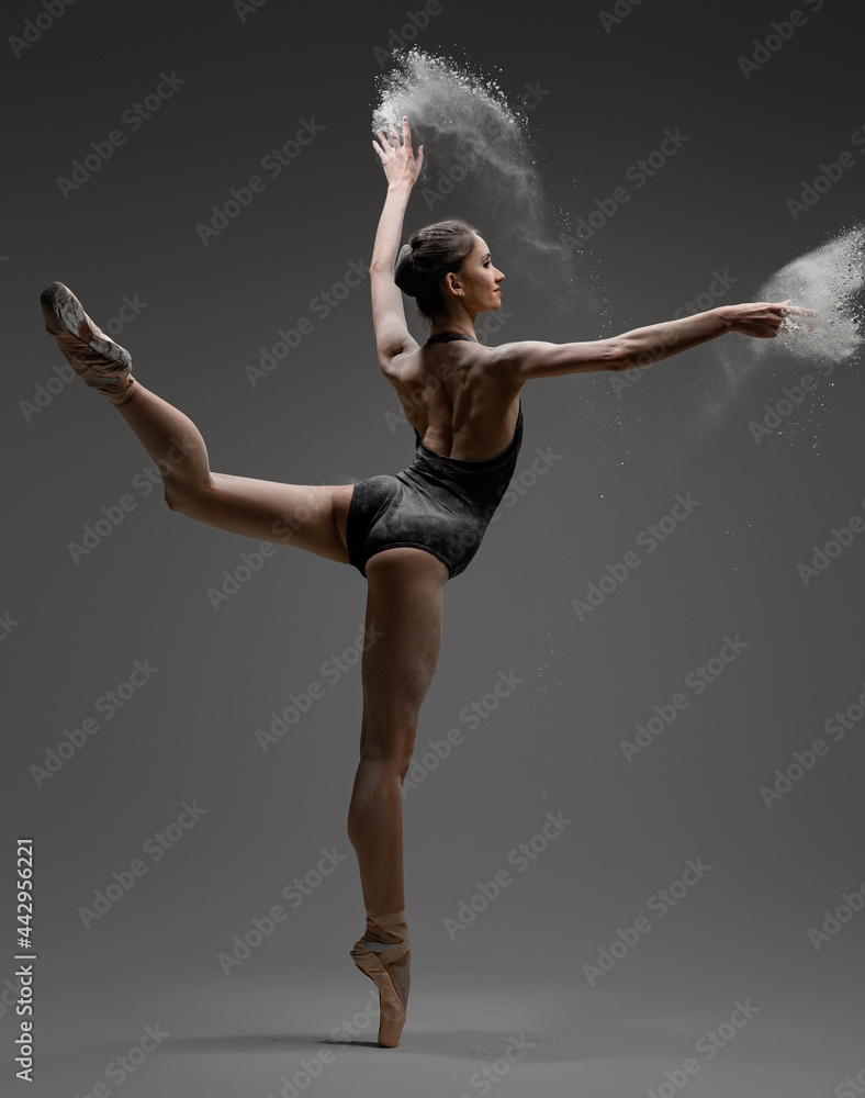 Artistic ballerina wearing black activewar and dancing