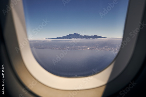 Aerial view from airplane window. Volcano Teide on Tenerife at sunny day. Canary Islands, Spain.
