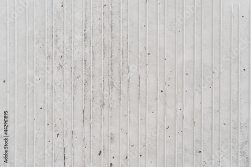 White metal texture background with vertical lines and small dirt spots.