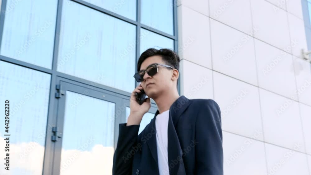 Portrait of a busy man holding a laptop in his hands and talking on the phone. Portrait of a busy man holding a laptop in his hands and talking on the phone.