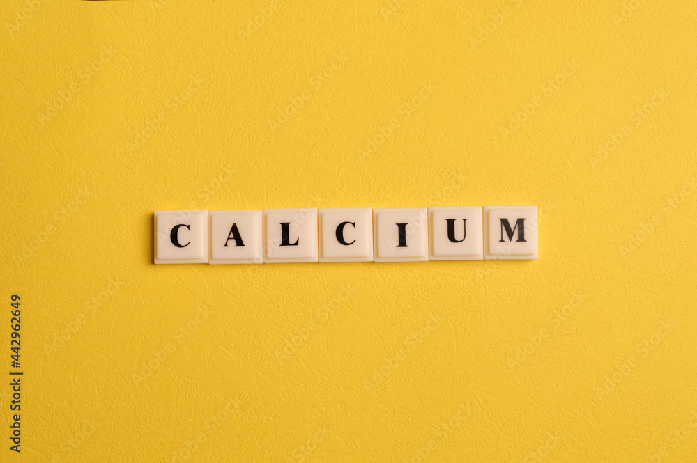 Square letters with text CALCIUM isolated on yellow background Square letters with text CALCIUM isolated on yellow background
