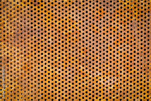Old rusty metal canvas with holes. Retro style. Close-up. Background, wallpaper, texture, cover.