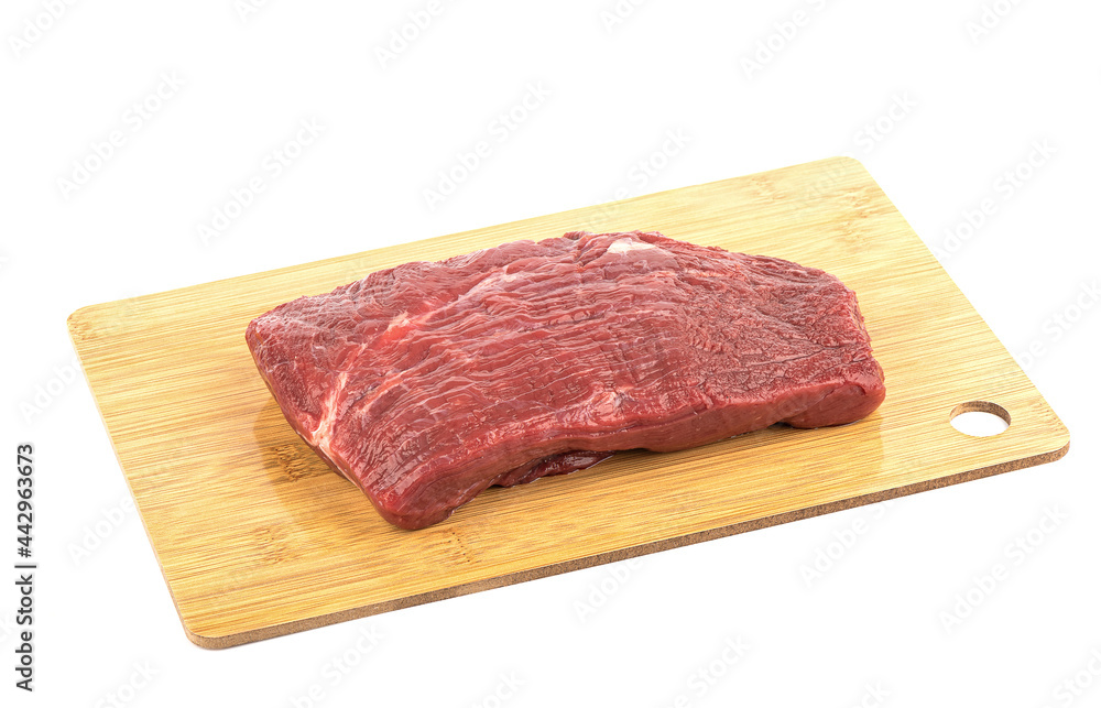 Piece of fresh, raw beef on a cutting board isolated on a white background. Piece of fresh, raw beef on a cutting board isolated on a white background.