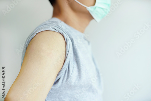 A man wear face mask showing his shoulder on white background 