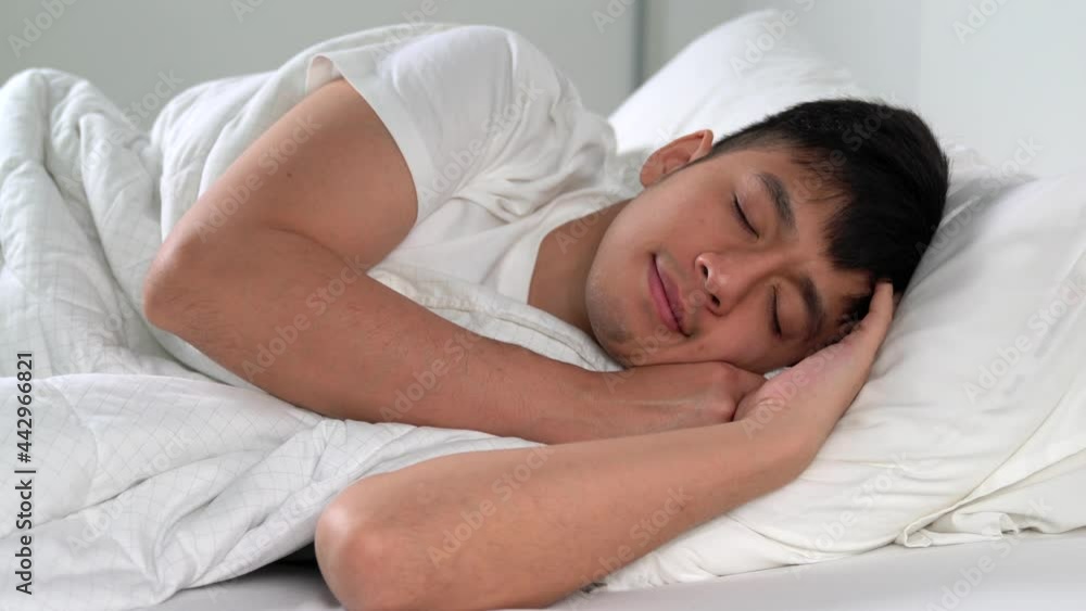 Happy Young Asian man sleep in comfortable bed in the morning. Happy Young Asian man sleep in comfortable bed in the morning.