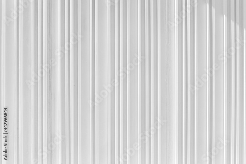 Decorative concrete vertical groove pattern of a building facade. Grooved White cement background