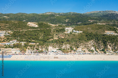 Drone view of scenic beach with white sand and turquoise sea, Greek islands.