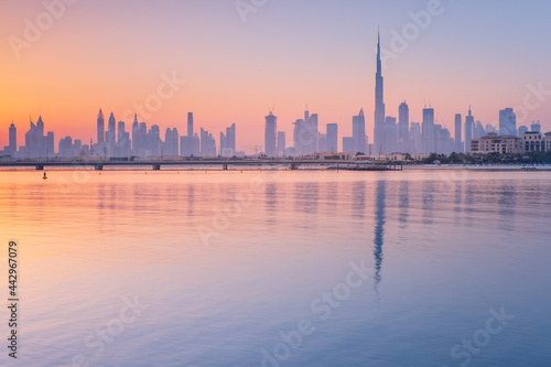 sea bay with reflections of skyscrapers in water in Dubai in the morning with copy space