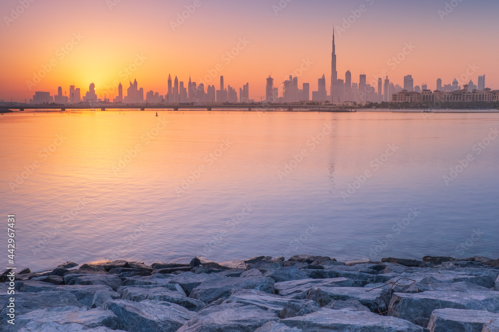 calm morning in bay with view to Dubai in sunrise with copy space