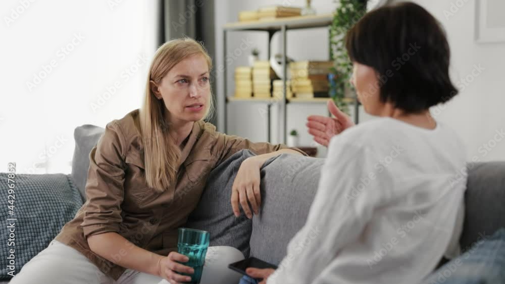 Business women talking on couch Business women talking on couch