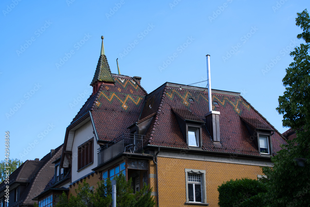 Pitched roof with beautiful colored pattern on a sunny summer morning. Photo taken July 2nd, 2021, Zurich, Switzerland.