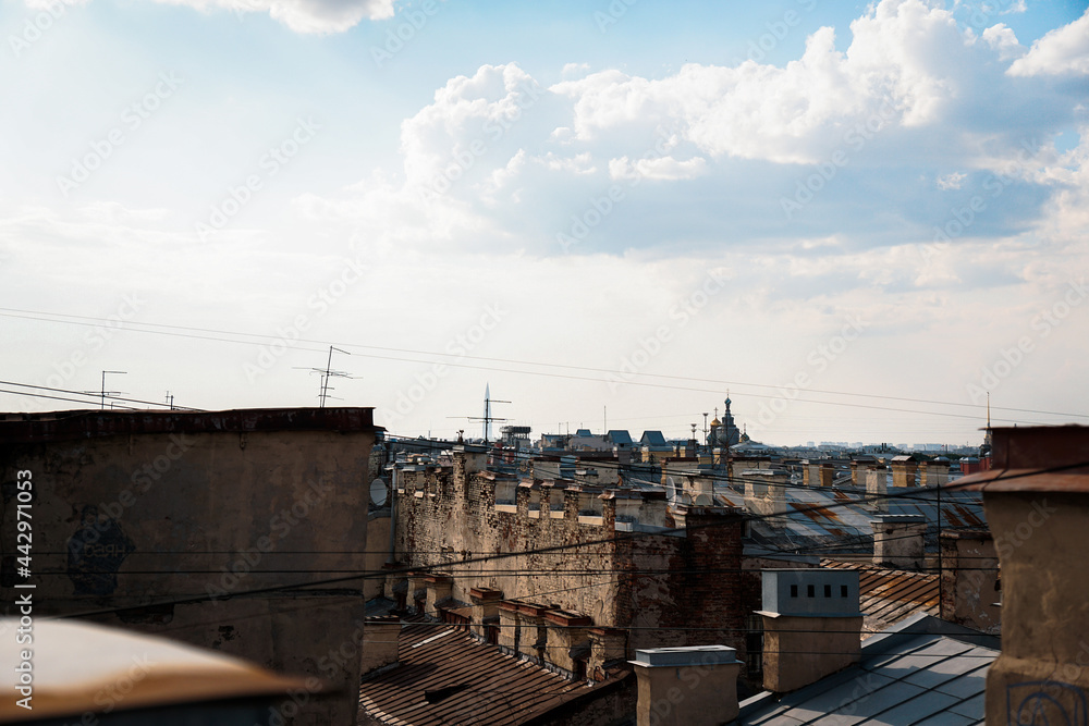 Naklejka premium Cityscape view over the rooftops of St. Petersburg. View of the rooftops against the sky