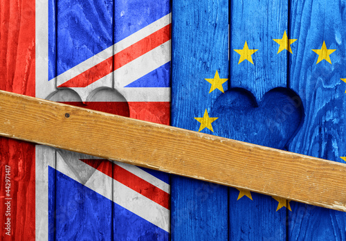 Closed wooden window shutters with UK and EU flags