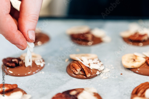 Close up of chef making chocolate desserts inside chocolate shop - Focus on fingers