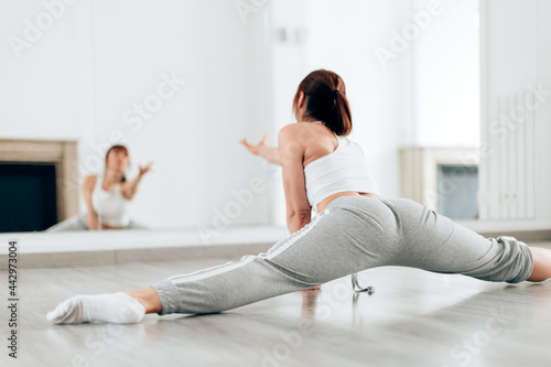 Professional dancer woman doing dance routine session at home studio - Focus on back