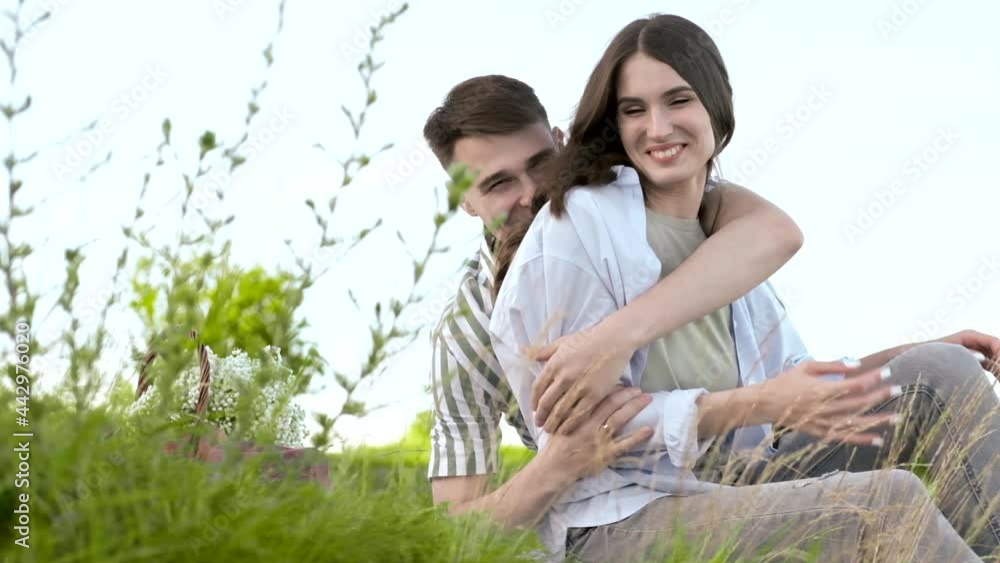 Slow motion. Portrait of a happy young family hugging and having a rest Slow motion. Portrait of a happy young family hugging and having a rest