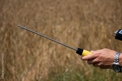 hand holds a noise metering sensor on the wrist watch 