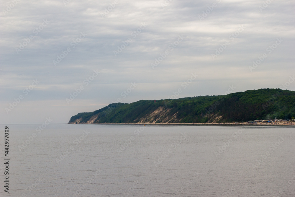 demi-island falling into the sea in a cloudy weather demi-island falling into the sea in a cloudy weather