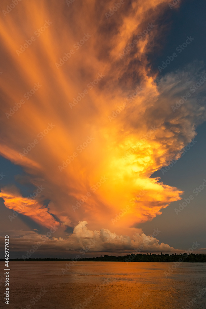Indonesia West Papua Raja Ampat. Brilliant clouds lit at sunset.