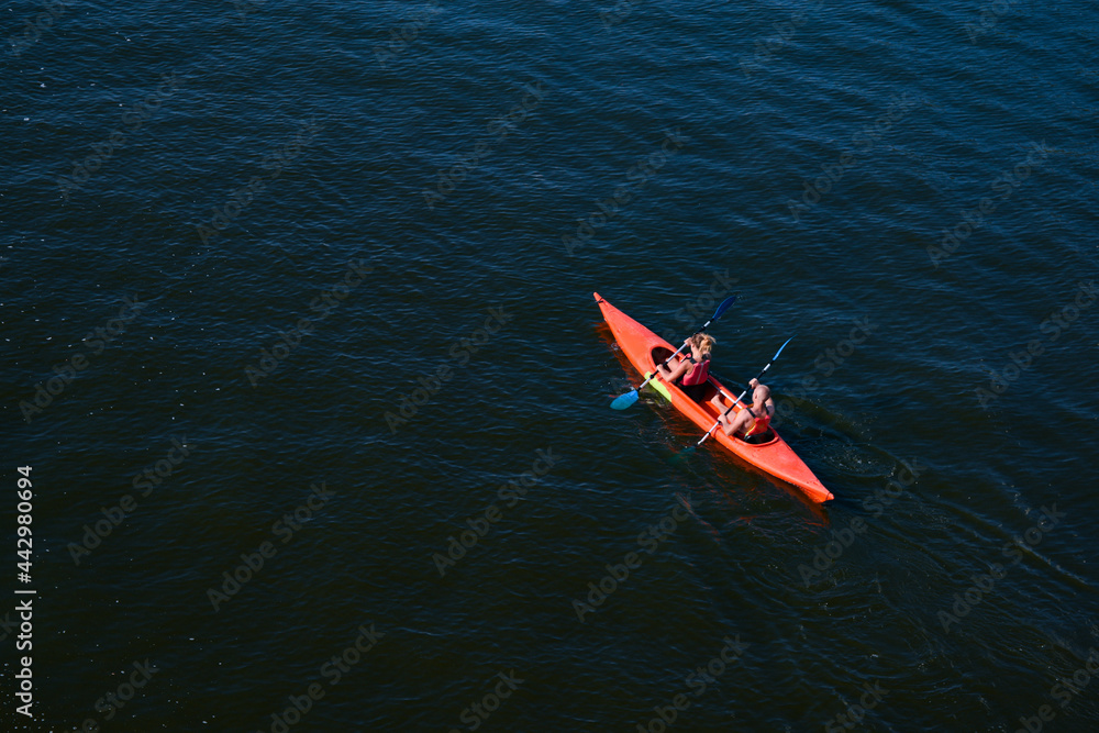 Top view of a man and a woman in a kayak floating on the river. Sports recreation on the water. Physical education and movement. UKRAINE, KIEV, JUNE, 2021