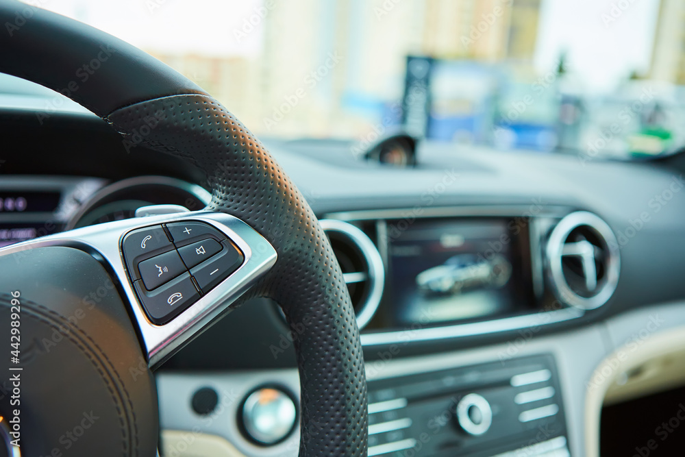 Control buttons on the steering wheel of a car Control buttons on the steering wheel of a car
