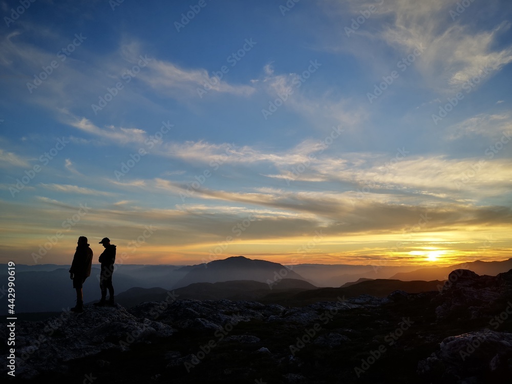 silhouette of hikers in the sunset
