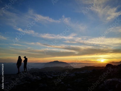 silhouette of hikers in the sunset