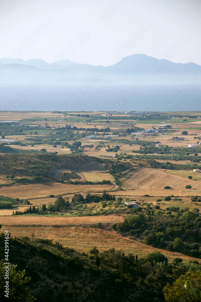view from hill over sea and fields