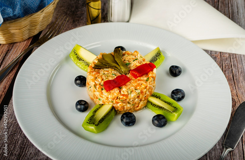 Olivier salad with kiwi fruit. Restaurant menu