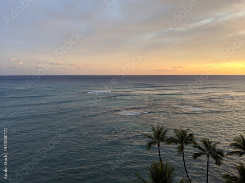 Aerial of Dusk on the oeacn with waves rolling in off Waikiki