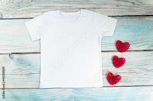 Blank white t-shirt with heart decor, unisex valentine's day apparel mock up. Stock photo.