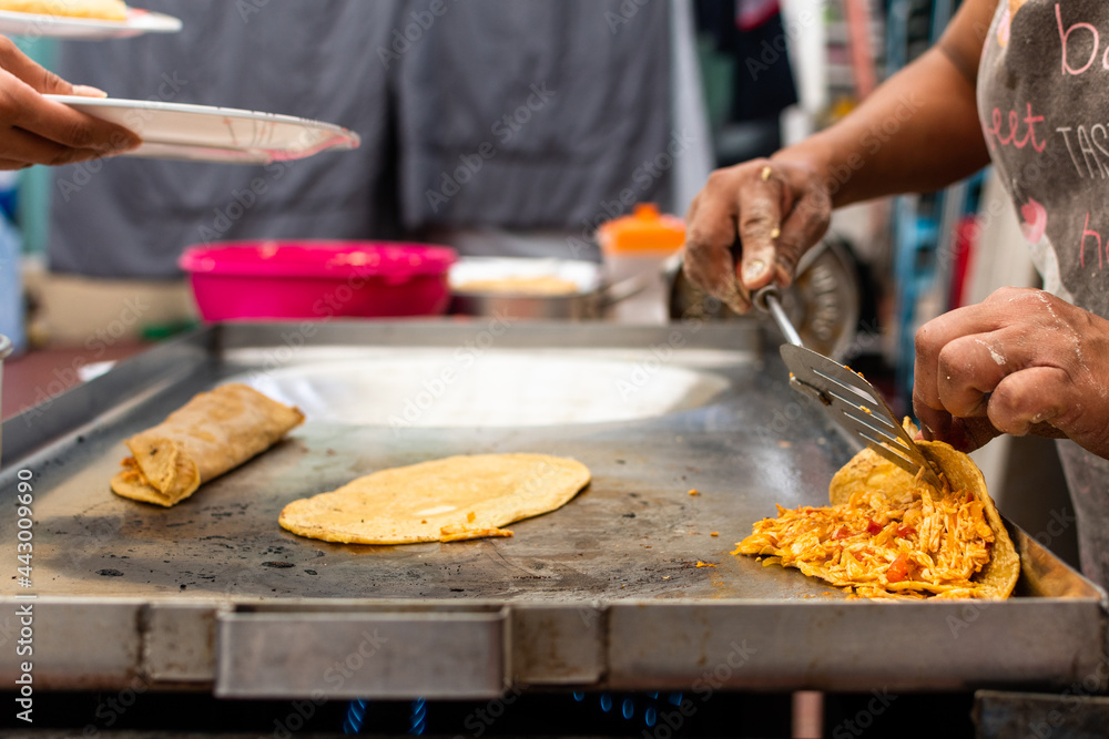woman's hand preparing a typical mexican food as a quesadillas, sopes, huaraches and more