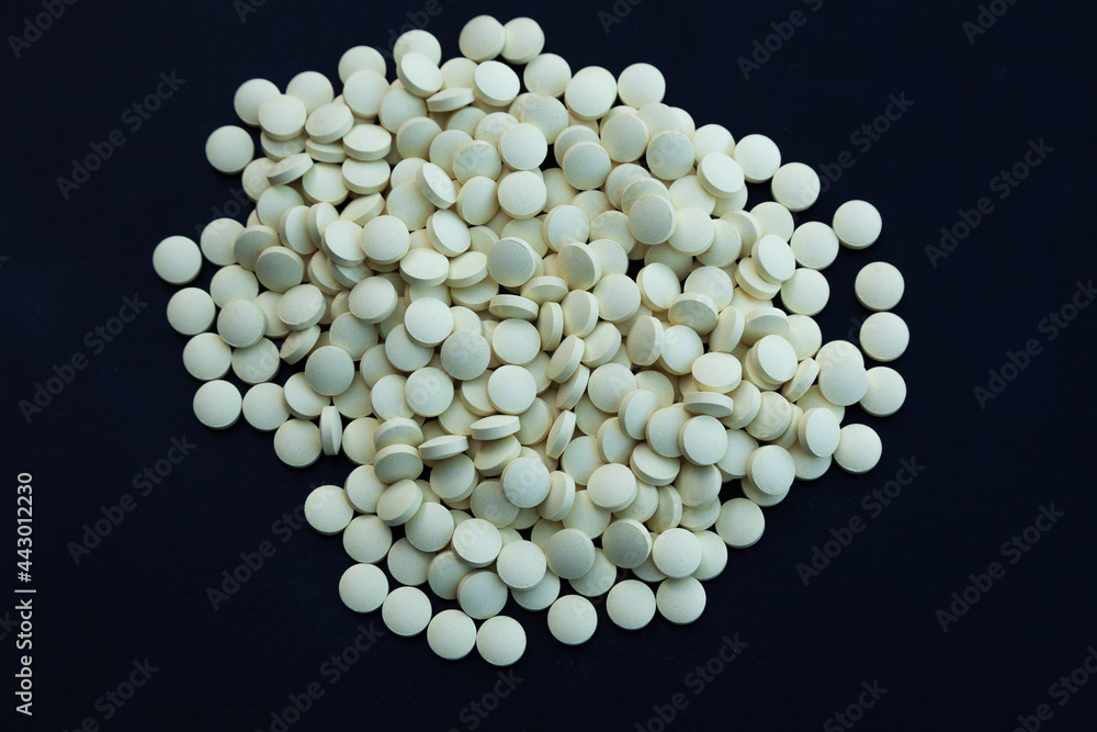 Heap of white pills on a black background. Heap of white pills on a black background.