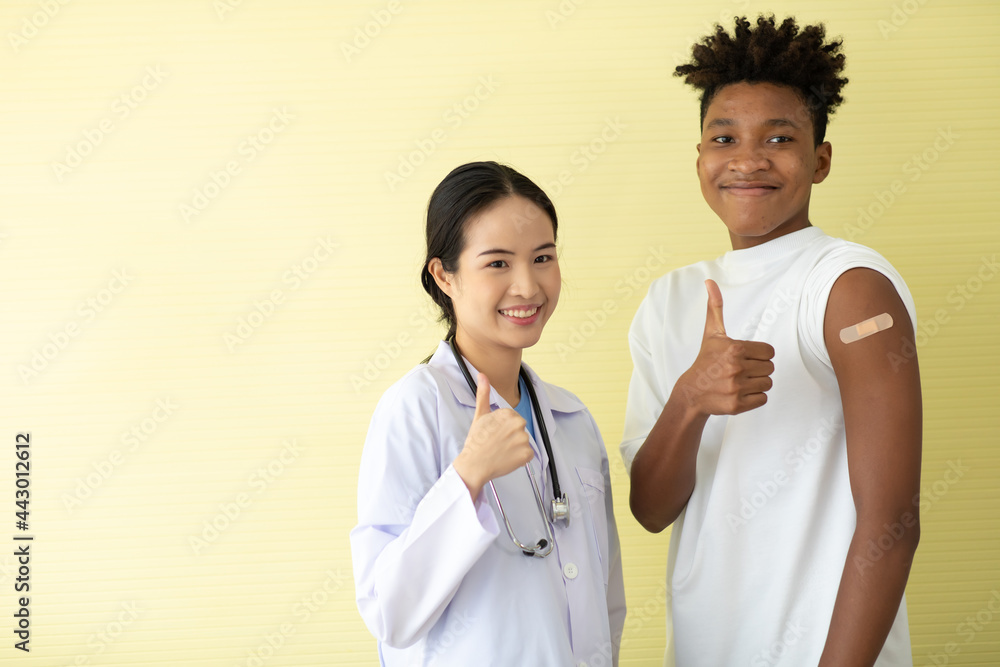 portrait asian woman doctor and black man show thumb up or good sign after injection vaccine . vaccinated against coronavirus in hospital portrait asian woman doctor and black man show thumb up or good sign after injection vaccine . vaccinated against coronavirus in hospital
