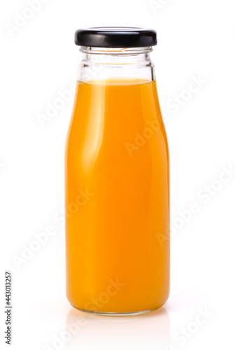 Orange juice in glass bottle isolated on white.