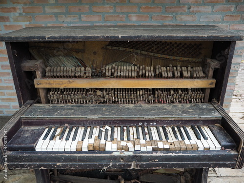 Close up of an old broken piano that doesn't work.
