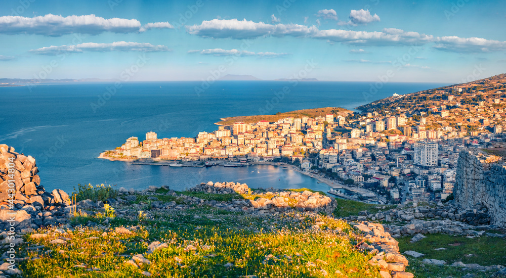 Aerial morning cityscape of Saranda. Bright spring seascape of Ionian sea. Picturesque outdoor scene of Albania, view from Lekursi Castle. Traveling concept background.