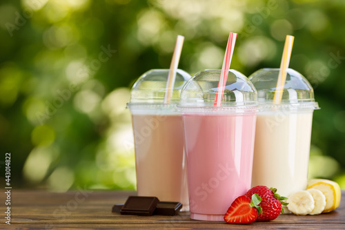 Fotografie, Obraz set of different milkshakes in disposable plastic glasses