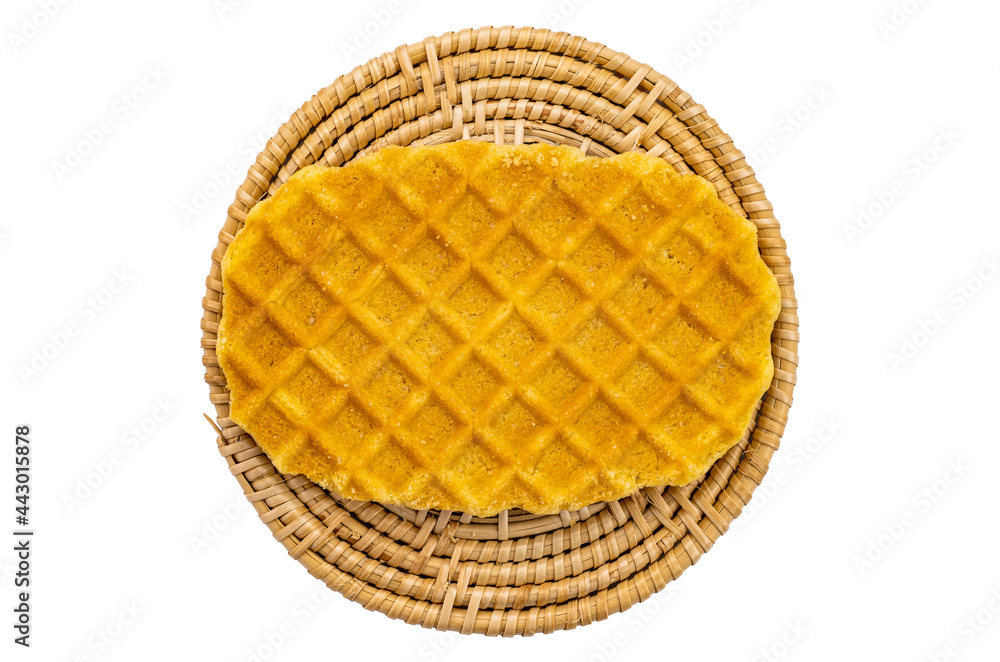 Top view of sweet homemade crispy waffles on wicker mat on white background. Top view of sweet homemade crispy waffles on wicker mat on white background.