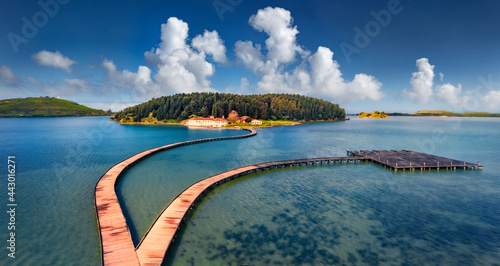 Fototapeta Naklejka Na Ścianę i Meble -  Aerial landscape photography. Fantastic morning view of St Mary's Monastery and wooden pier. Magnificent spring seascape of Narta Lagoon. Beautiful outdoor scene of Albania, Europe.