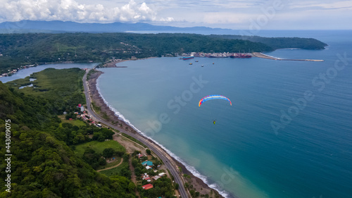 Beautiful aerial view of the extreme sport of paragliding on the Beach and mountains of Costa Rica 