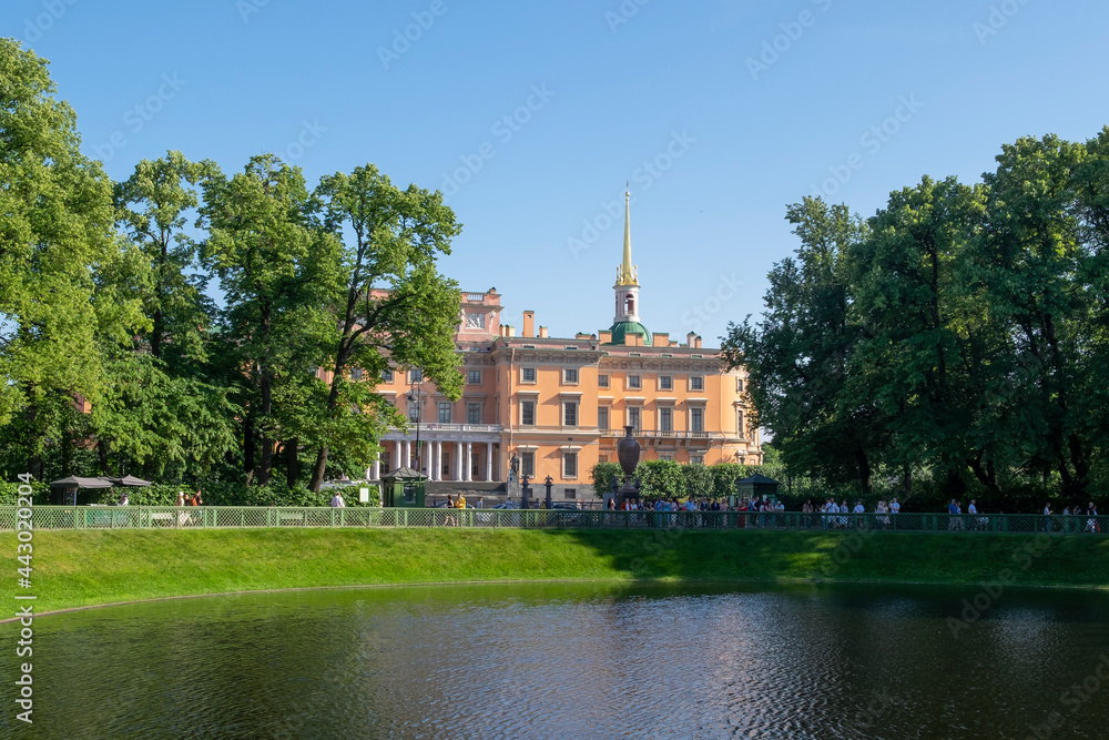  View of the Mikhailovsky Engineering castle through the Karpiev pond of the Summer Garden. Local tourism.