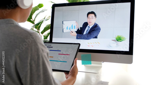Video conference, Work from home, Asian man making video call to business team with virtual web while holding digital tablet, Contacting colleague by conference on laptop computer at home
