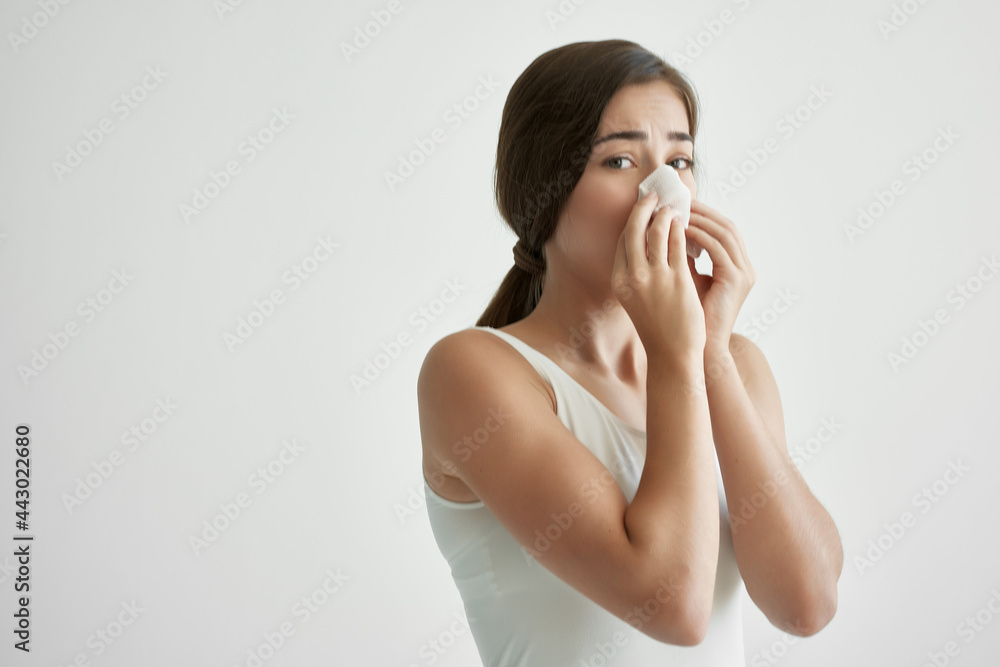 woman in white t-shirt handkerchief allergy cold runny nose woman in white t-shirt handkerchief allergy cold runny nose