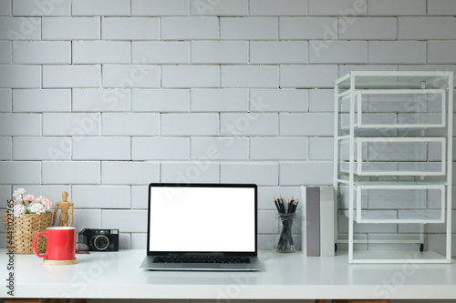 Modern workspace with computer with blank screen and equipment on white table.Blank screen for your information.