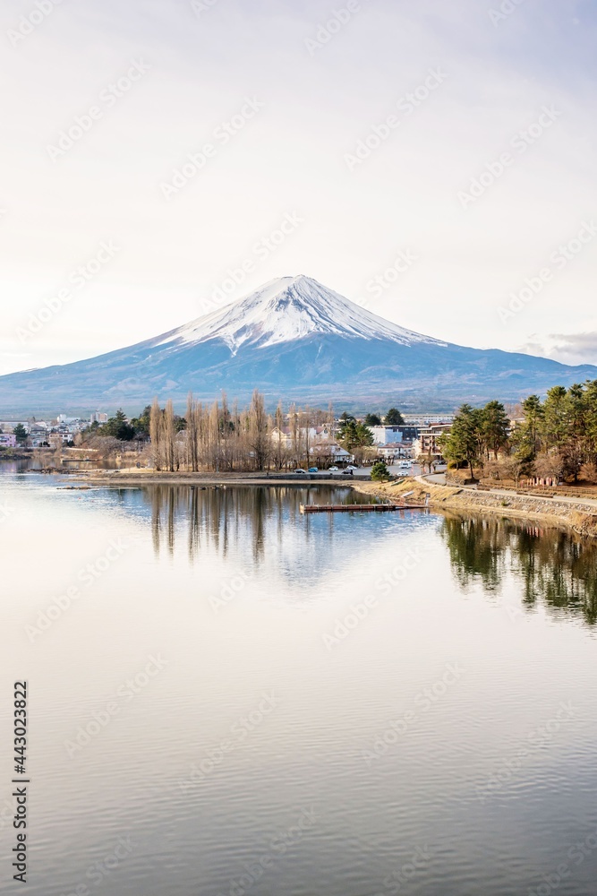 Landscape photo of Mount Fuji and its reflection on the water in the low key tone taken from Lake Kawaguchiko, Yamanashi Tokyo Japan
