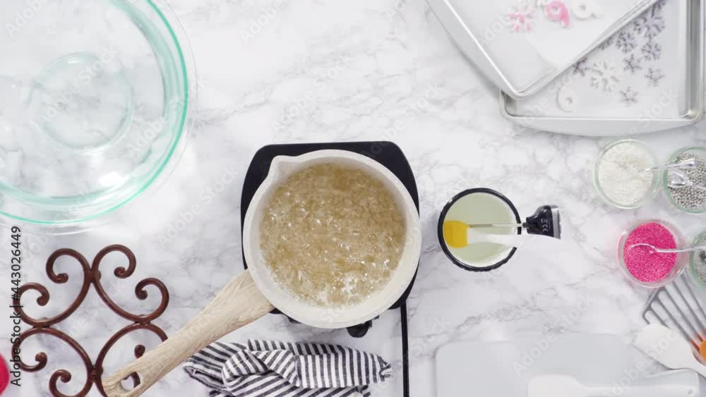 Flat lay. Step by step. Caramelizing sugar in a small cooking pot over the small electric stove. Flat lay. Step by step. Caramelizing sugar in a small cooking pot over the small electric stove.