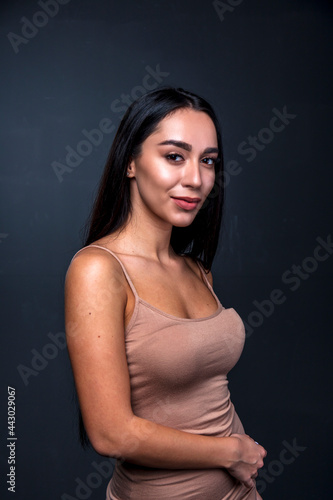 portrait of a young woman in the studio on a dark background